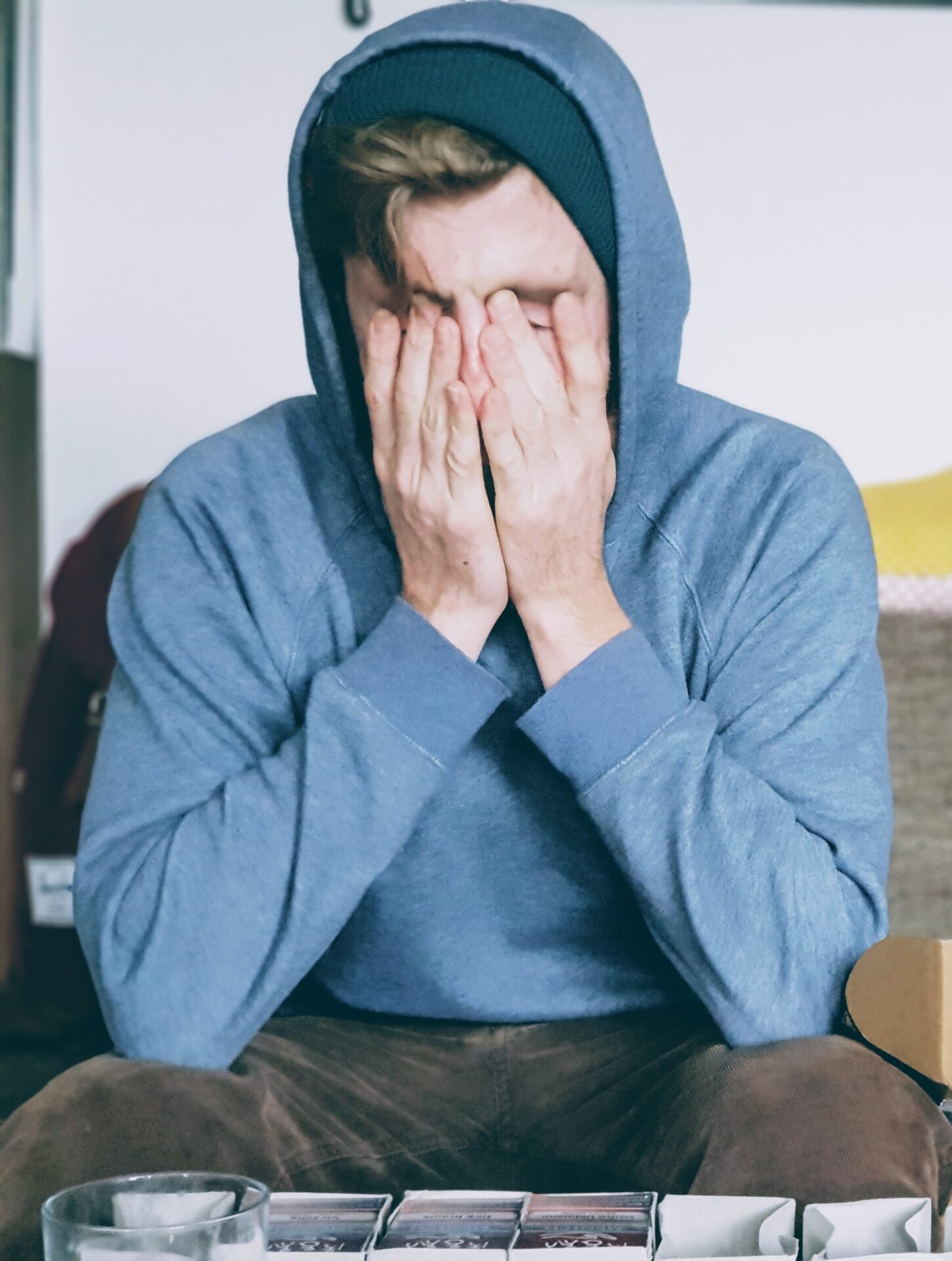 Young person with their head in their hands