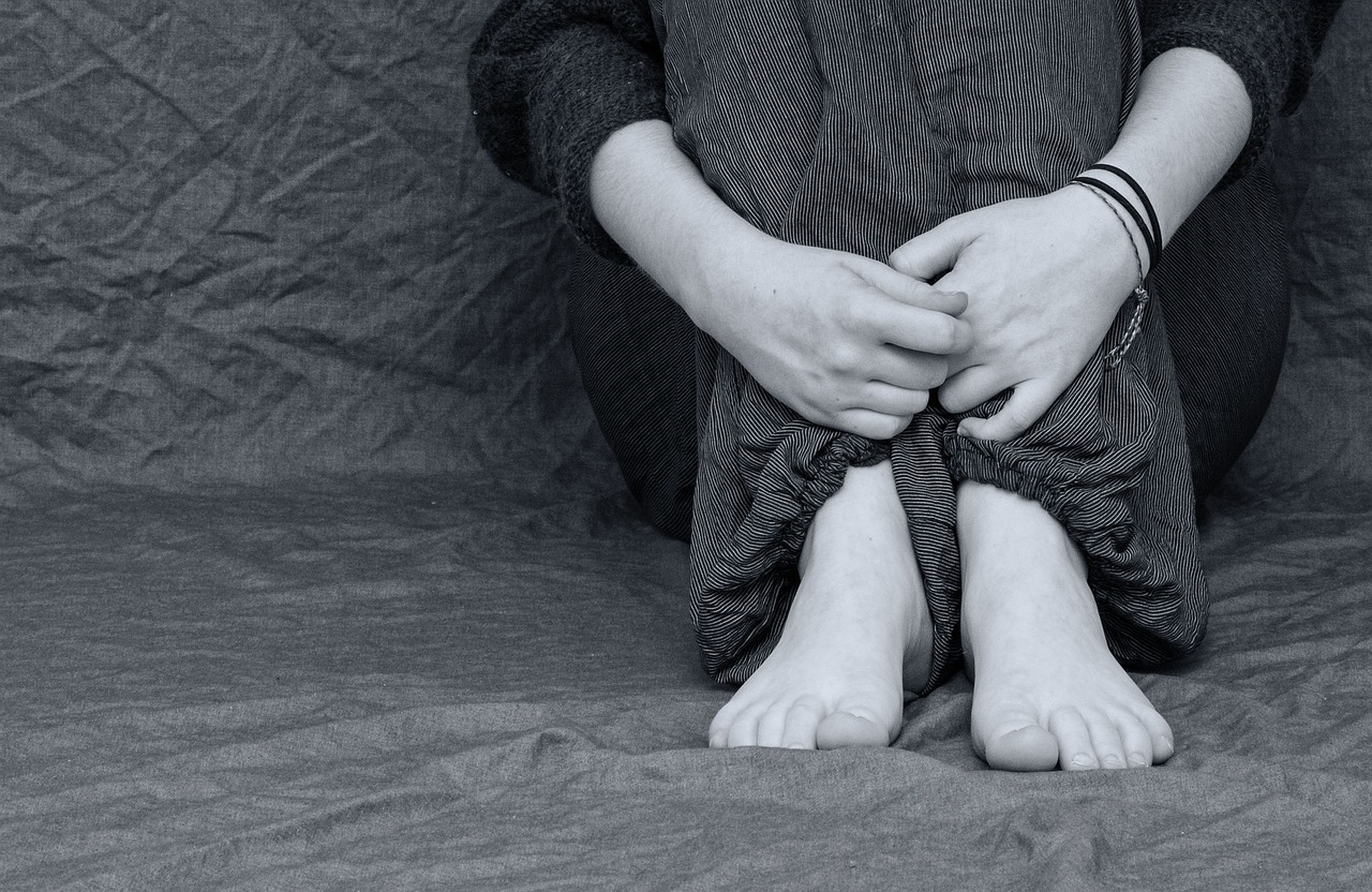 girl crouched in corner
